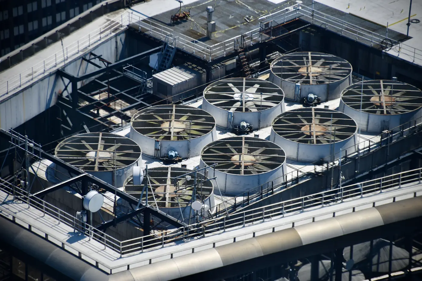 Cooling tower fan array on an industrial plant roof requiring descaling