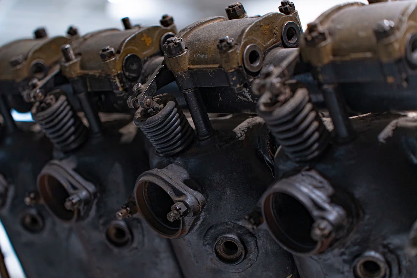 Engine components covered in baked-on grime before spray washing