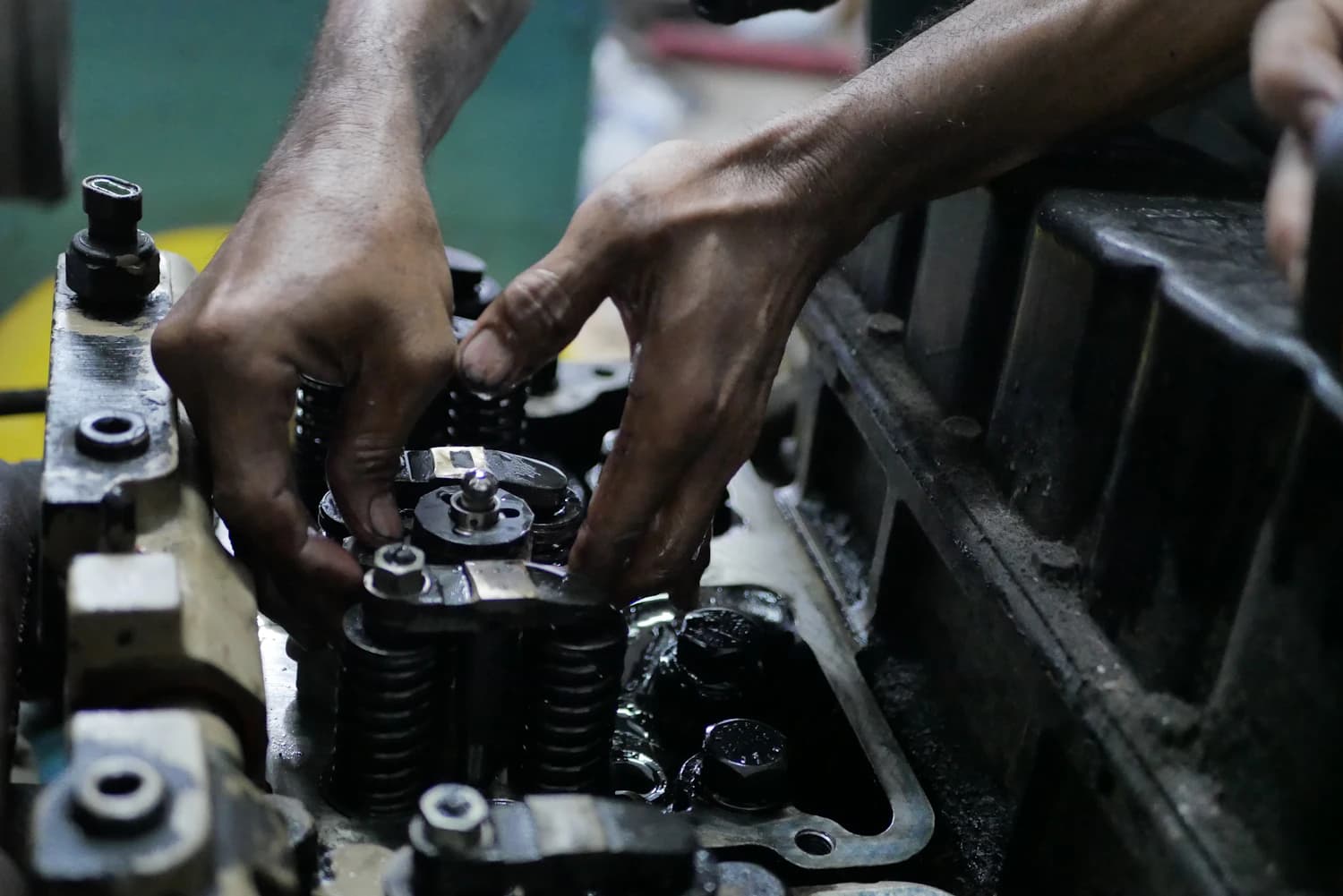 Engine cylinder head being cleaned by hand with a solvent degreaser